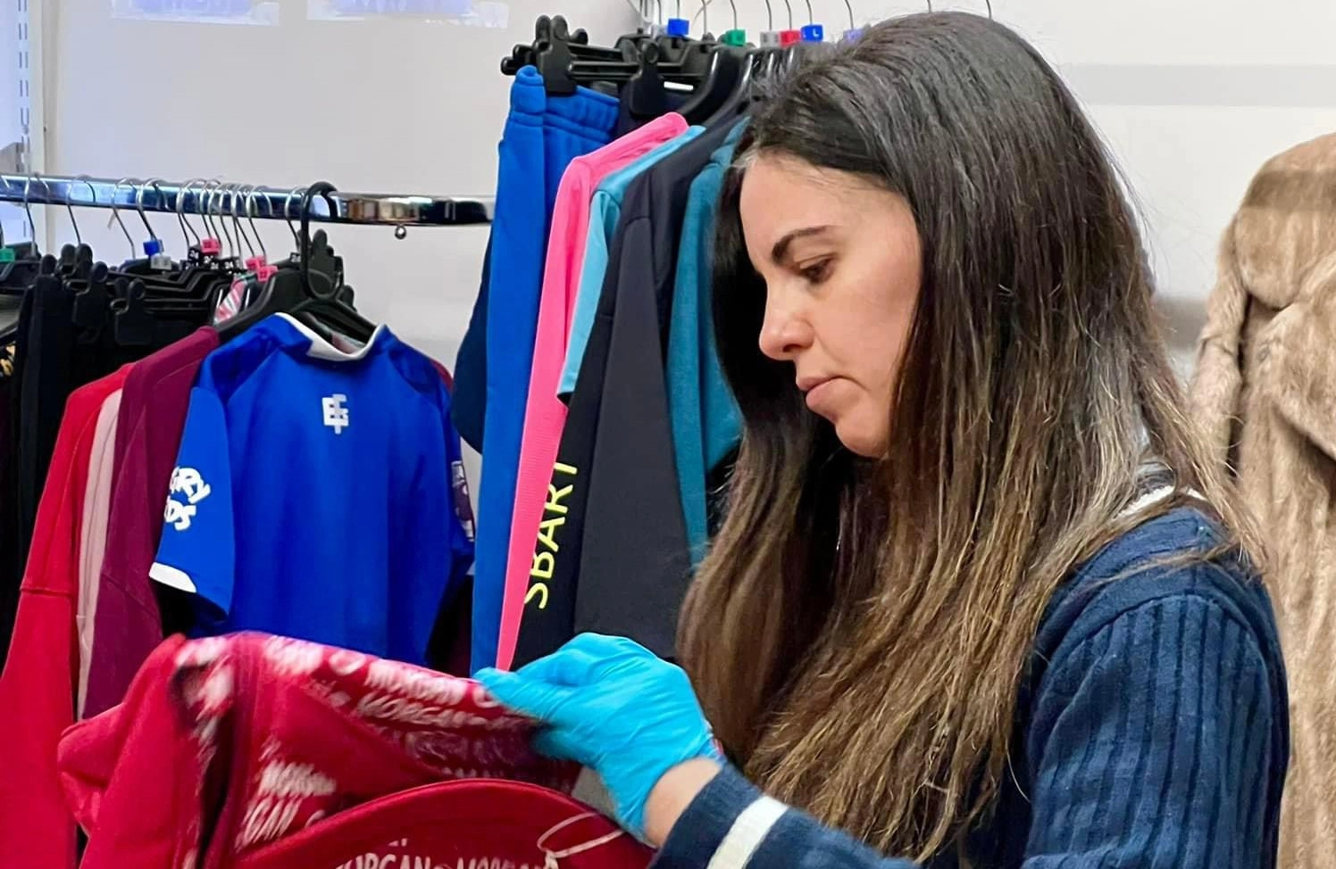 .A shop volunteer sorting stock