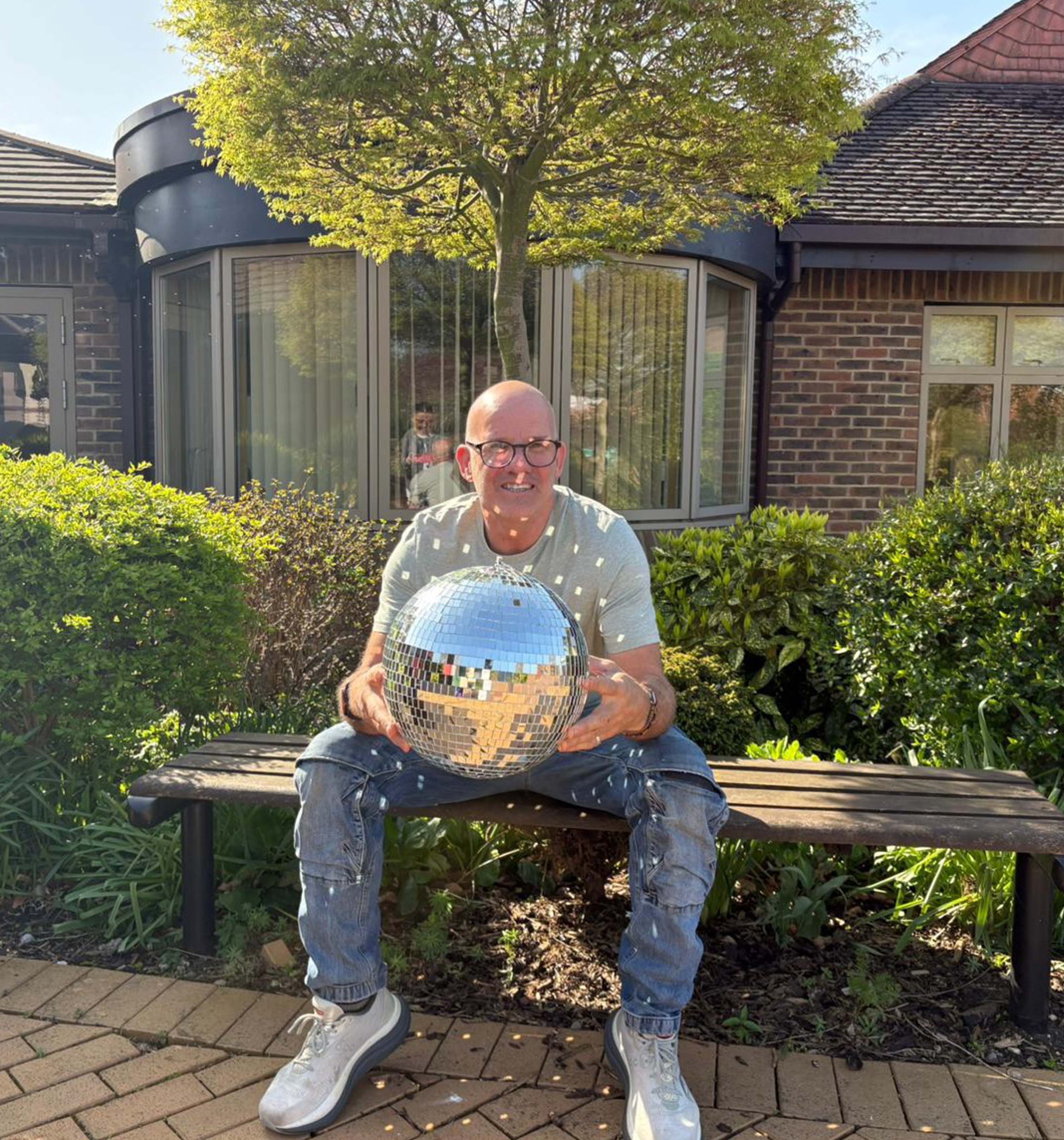 A photo of Sean holding the Strictly St. Rocco's Glitter ball