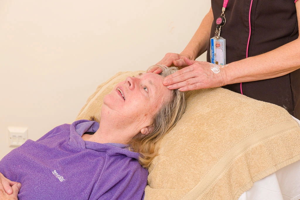 A nurse massaging a patients neck