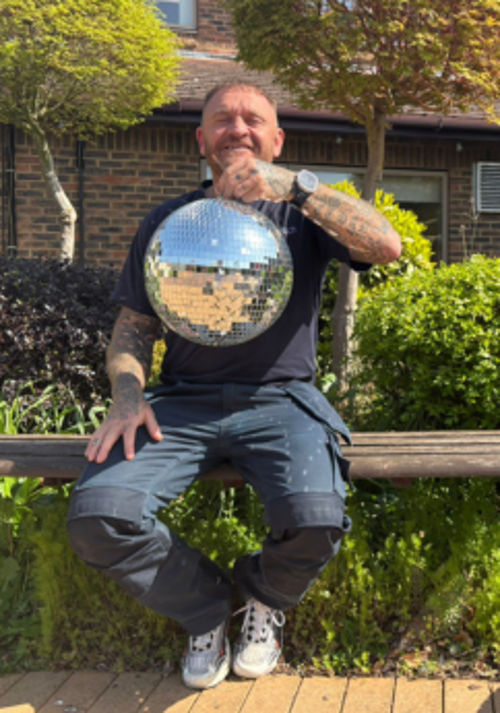 A photo of Louise holding the Strictly St. Rocco's Glitter ball