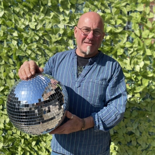 A photo of Andrew holding the Strictly St. Rocco's Glitter ball