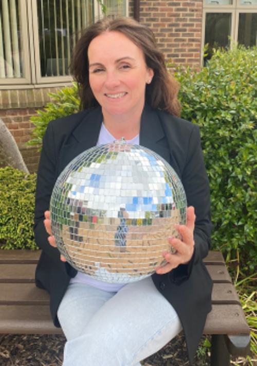 A photo of Steph holding the Strictly St. Rocco's Glitter ball
