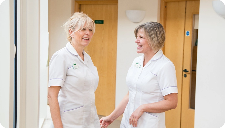 Two nurses laughing