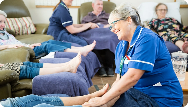 Reflexology session with nurse massaging a patients feet