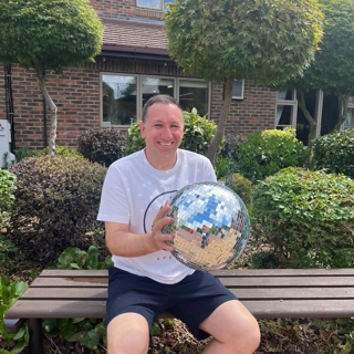 A photo of Andy holding the Strictly St. Rocco's Glitter ball