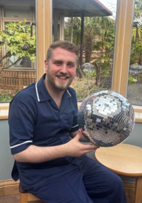 A photo of Jonathan holding the Strictly St. Rocco's Glitter ball