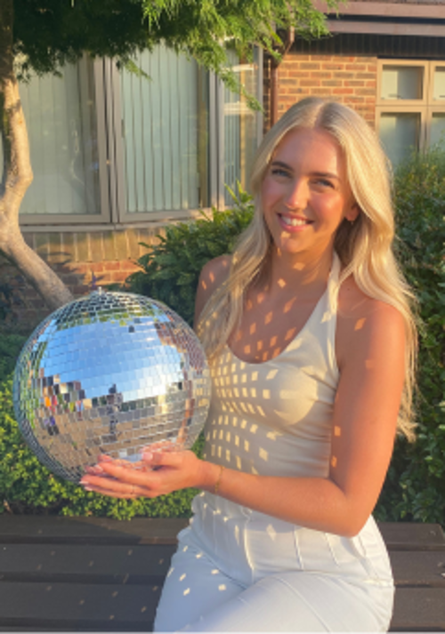 A photo of Louise holding the Strictly St. Rocco's Glitter ball