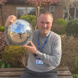 A photo of Gary holding the Strictly St. Rocco's Glitter ball