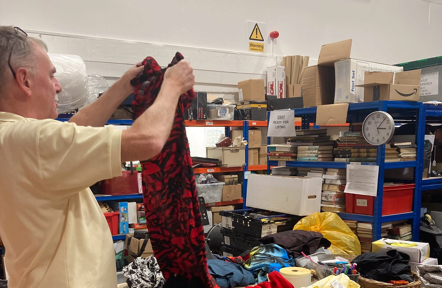 .A photo of a sorting centre volunteer sorting clothes